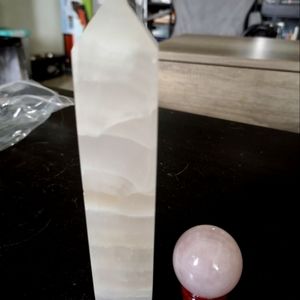 Large rose quartz tower and small rose quartz sphere with stand.